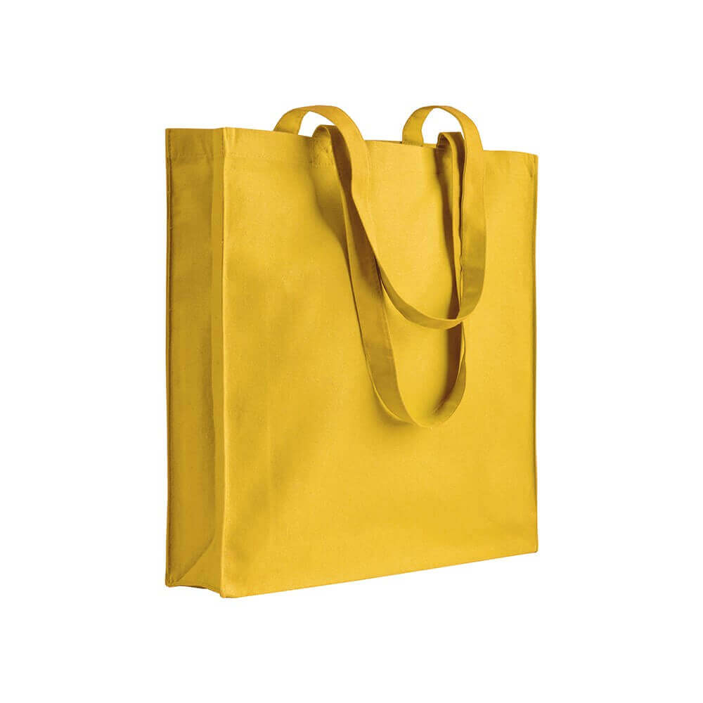 yellow color cotton bag with long handles